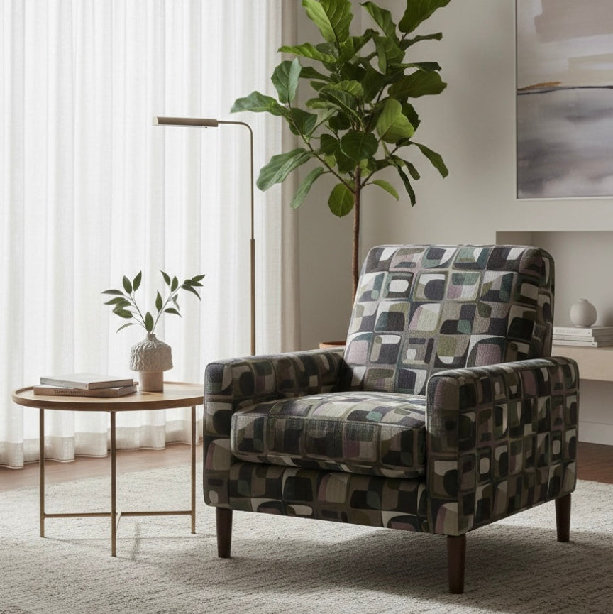Patterned armchair in a living room with a plant and side table.