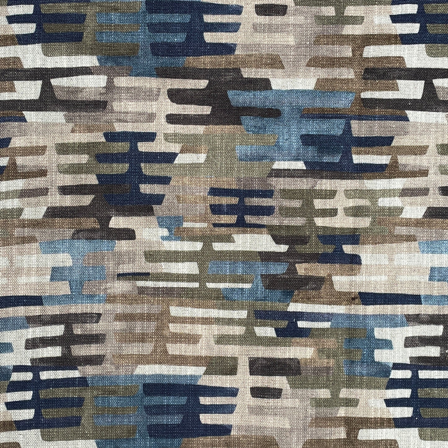 Patterned fabric with geometric design in brown, blue, and beige tones.