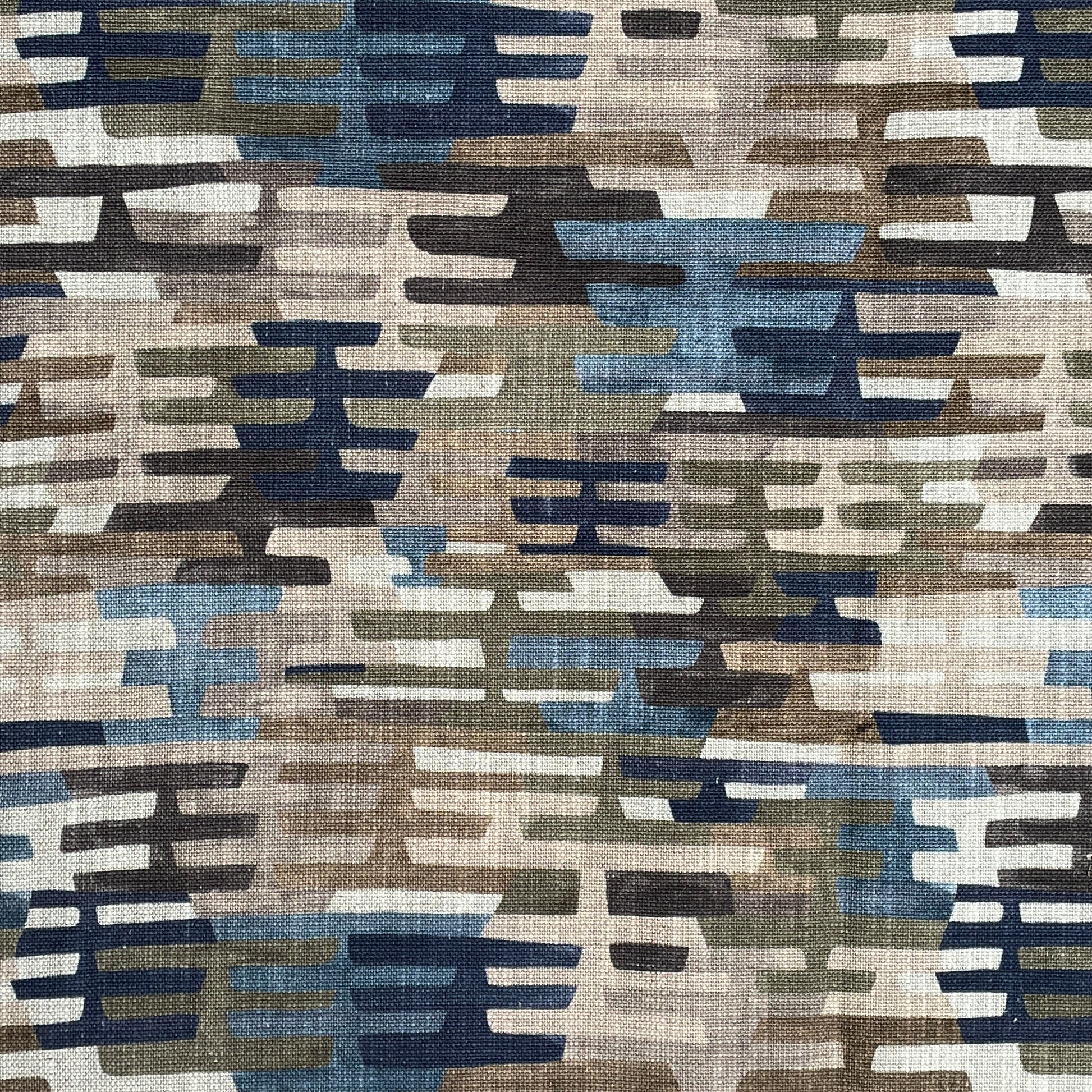 Patterned fabric with geometric design in brown, blue, and beige tones.
