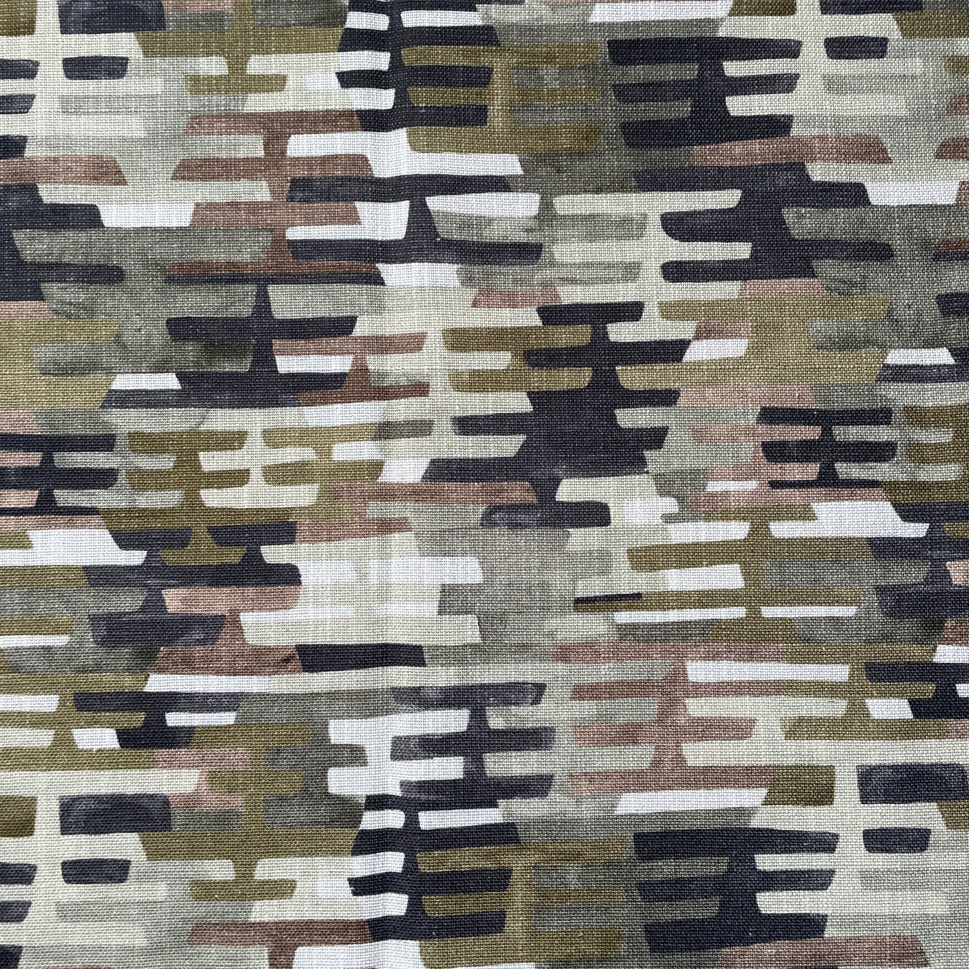Rhythem Patterned fabric with geometric design in brown, beige, black, and white.