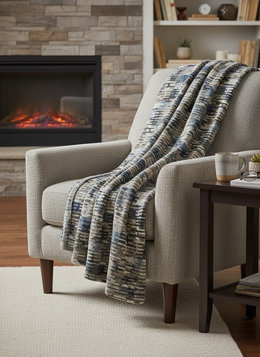 Cozy living room with a fireplace, armchair, and patterned throw blanket.