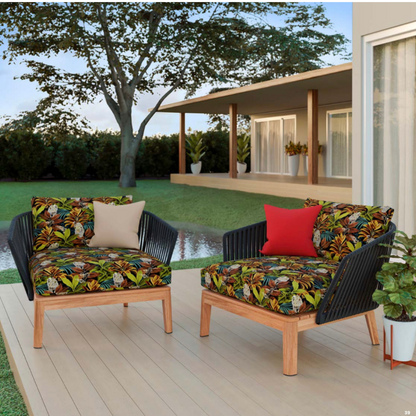 Two outdoor chairs with our Savanna Golden design with custom made squabs on a deck with a house and garden in the background.