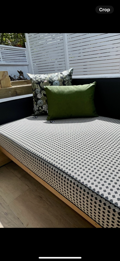 Outdoor custom made seating area with our relics design fabric plus our Duna Bandeira Green Terrario Preto cushions and our design on a wooden bench.