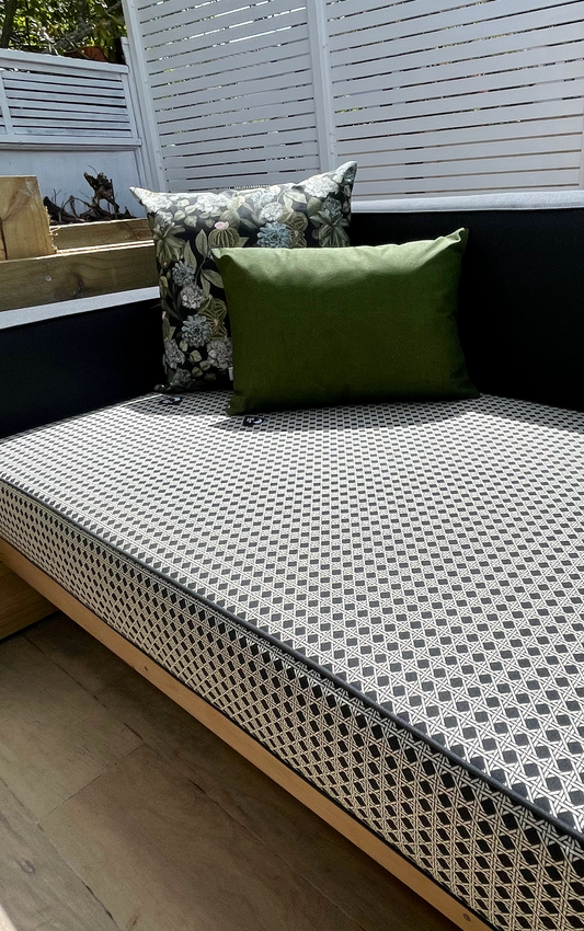 Outdoor custom made seating area with our relics design fabric plus our Duna Bandeira Green Terrario Preto cushions and our design on a wooden bench.